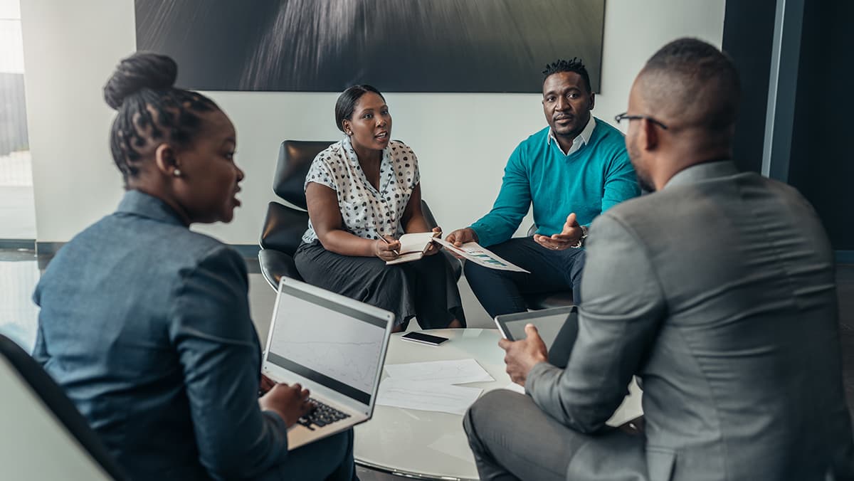 Black Nigerian business leaders in a strategic planning meeting at a modern Lagos office