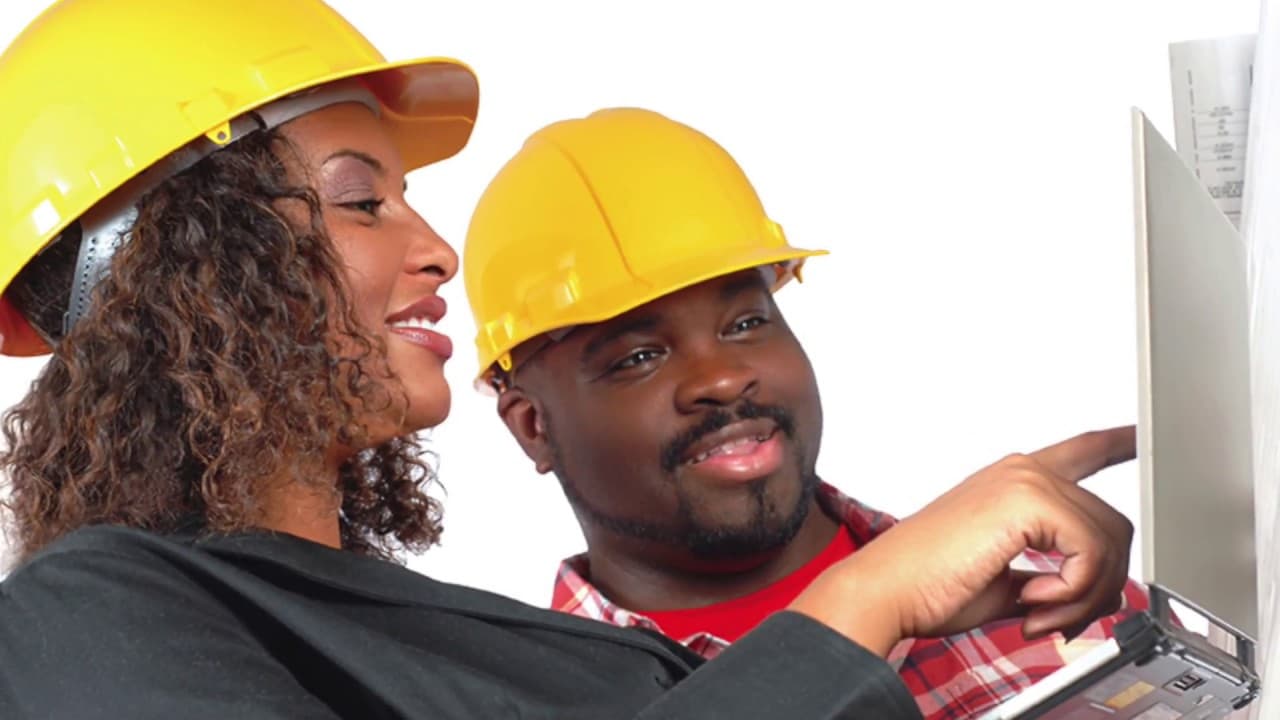 Black IoT engineer configuring a smart building sensor panel
